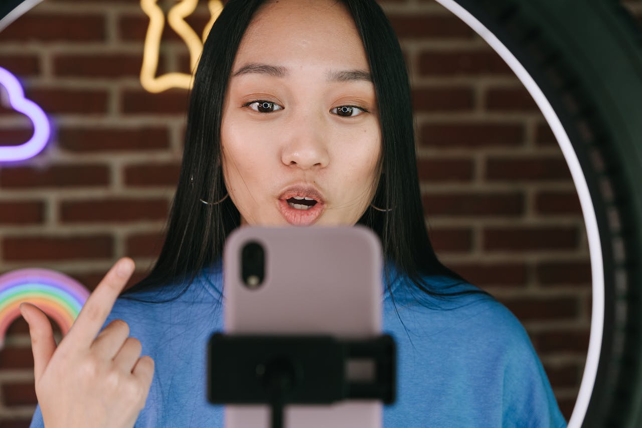 An influencer recording herself using a smartphone